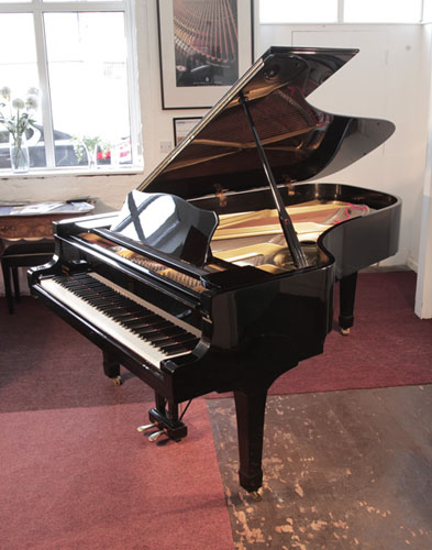 Reconditioned,  1980, Yamaha C7 grand piano with a black case and brass fittings. Piano has an eighty-eight note keyboard and a two-pedal lyre.  