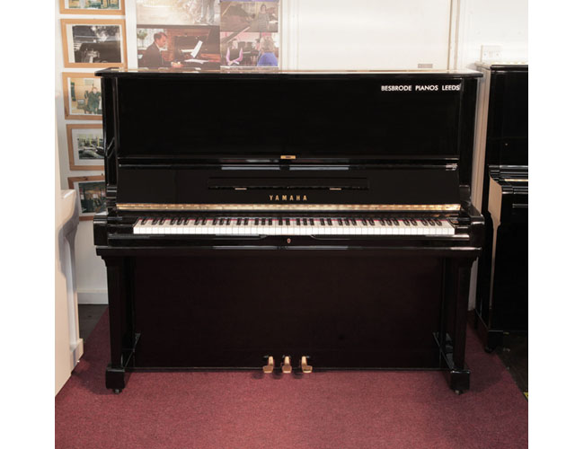 Reconditioned, 1974, Yamaha U3 upright piano for sale with a black case and brass fittings. Piano has an eighty-eight note keyboard and three pedals. 
