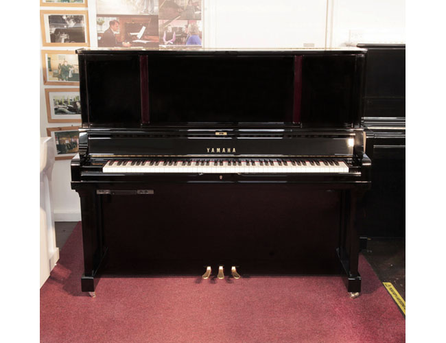 A 2019, YUS5 SH2 upright piano for sale with a black case and brass fittings. Piano has a fitted silent system. Condition as new. Piano has an eighty-eight note keyboard and three pedals.  