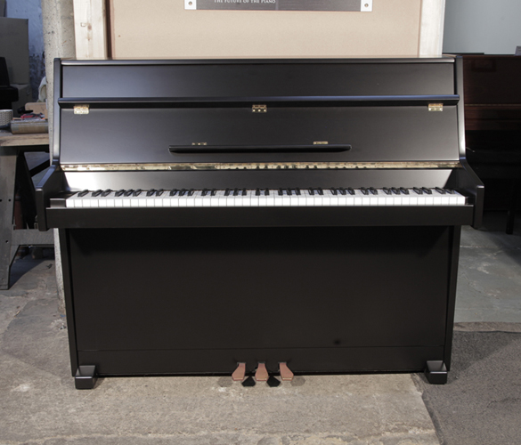 Piano for sale. Pre-owned, 1988, Young Chang U-109 upright piano with a black, satin case and brass fittings. Piano has an eighty-eight note keyboard and two pedals. 