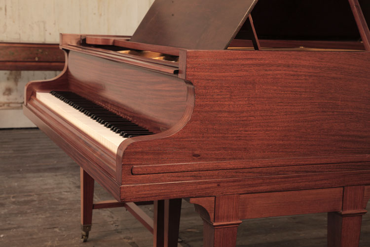Bechstein rounded piano cheek with a linear case moulding that wraps around the base of the cabinet