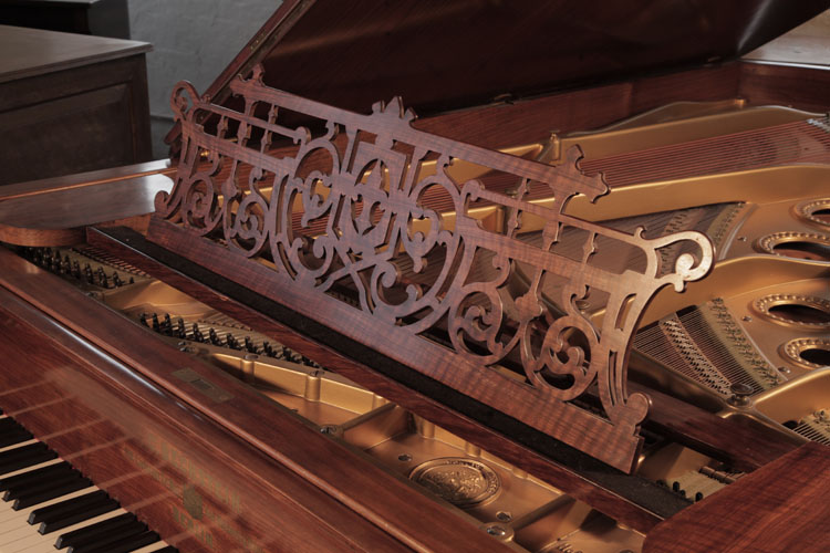 Bechstein Model D openwork music desk in a scrolling arabesque design with cantral C-scrolls, shield and fleur-de-lis motifs
