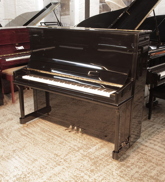 Reconditioned 2011, Besbrode upright piano for sale with a black gloss case and brass fittings. Piano has an eighty-eight note keyboard and three pedals.  