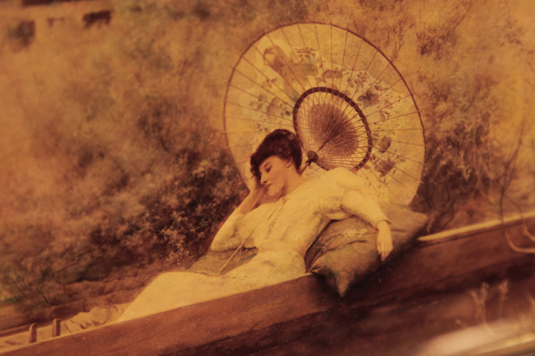 Crystoleum detail: A lady reclining on a cushion beneath a parasol