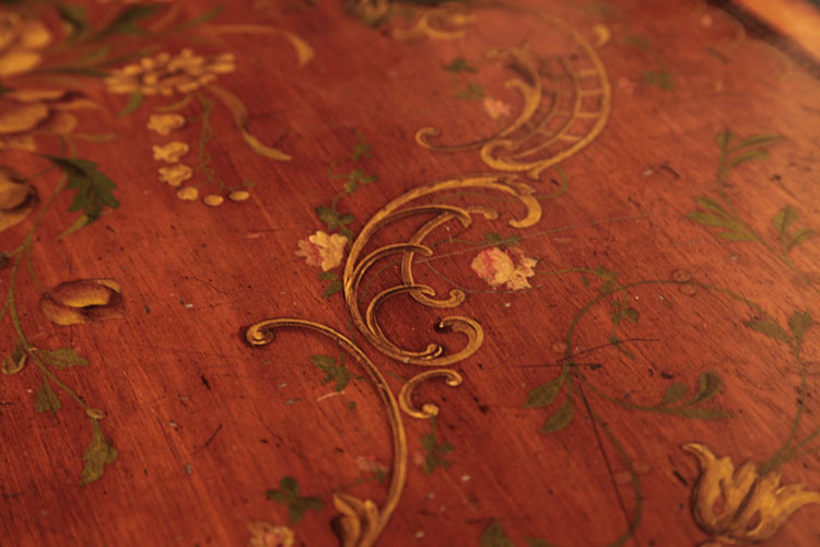 Hand-painted detail of lid featuring interlacing curvilinear C-scrolls, roses, lilly of the valley, mistletoe and foliage 