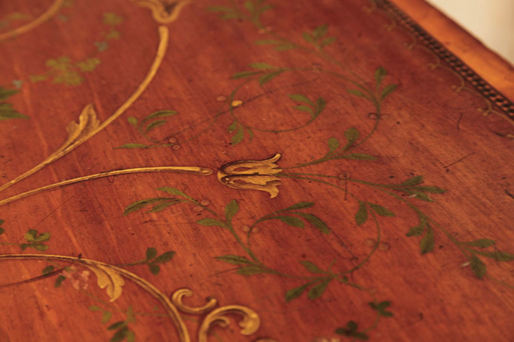 Hand-painted detail of lid featuring curvilinear motifs and mistletoe 