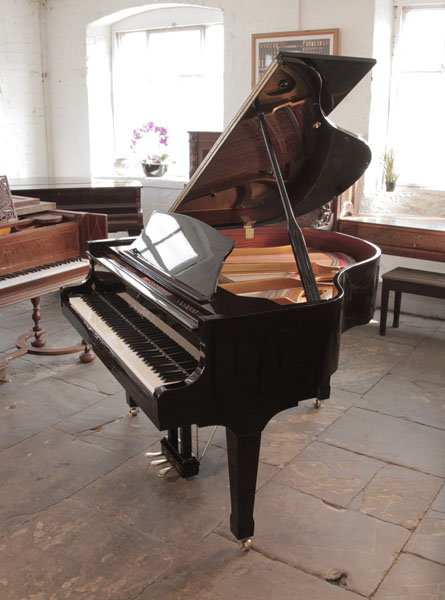 Carl Steinberg baby grand piano for sale with a black case and spade legs. Piano has an eighty-eight note keyboard and a three-pedal lyre.  