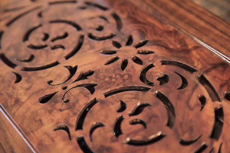 Stylised cut-out tendril and flower embellishment on music desk
