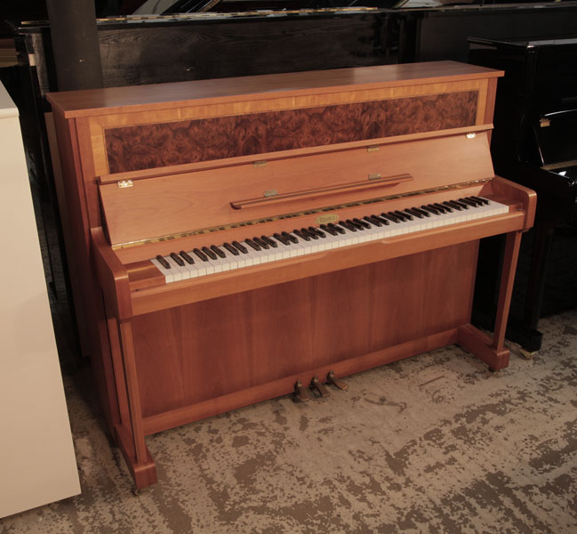 Reconditioned, 1992, Kemble upright piano with a walnut case and burr walnut front panel. Piano has an eighty-eight note keyboard.