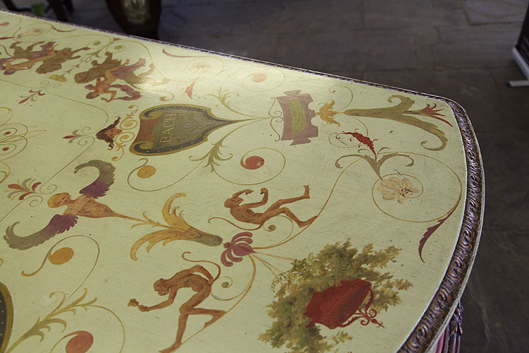 Hand-painted decoration covers the entire cabinet of this Pleyel grand piano. Here we can see composers names on pelta shields, monkeys, an angelic figurehead, arabesques, flowers and a hanging basket.